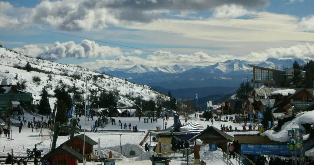 A Snow Covered Mountain With People And Buildings
