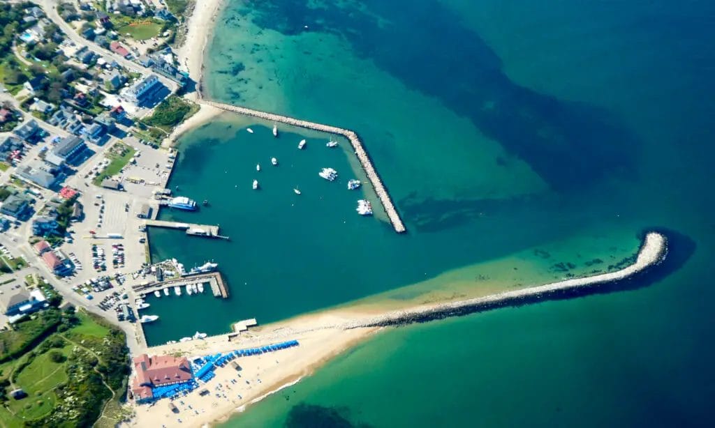 a aerial view of a beach with boats and a pier