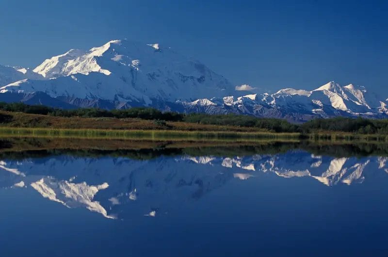 a mountain with a reflection of a lake