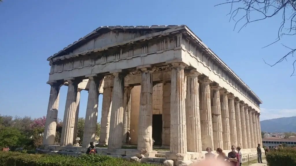 a building with columns and people in the background