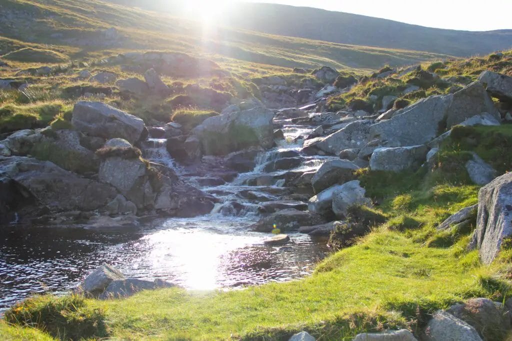 a river running through a grassy area in Wicklow National Park, Co. Wicklow