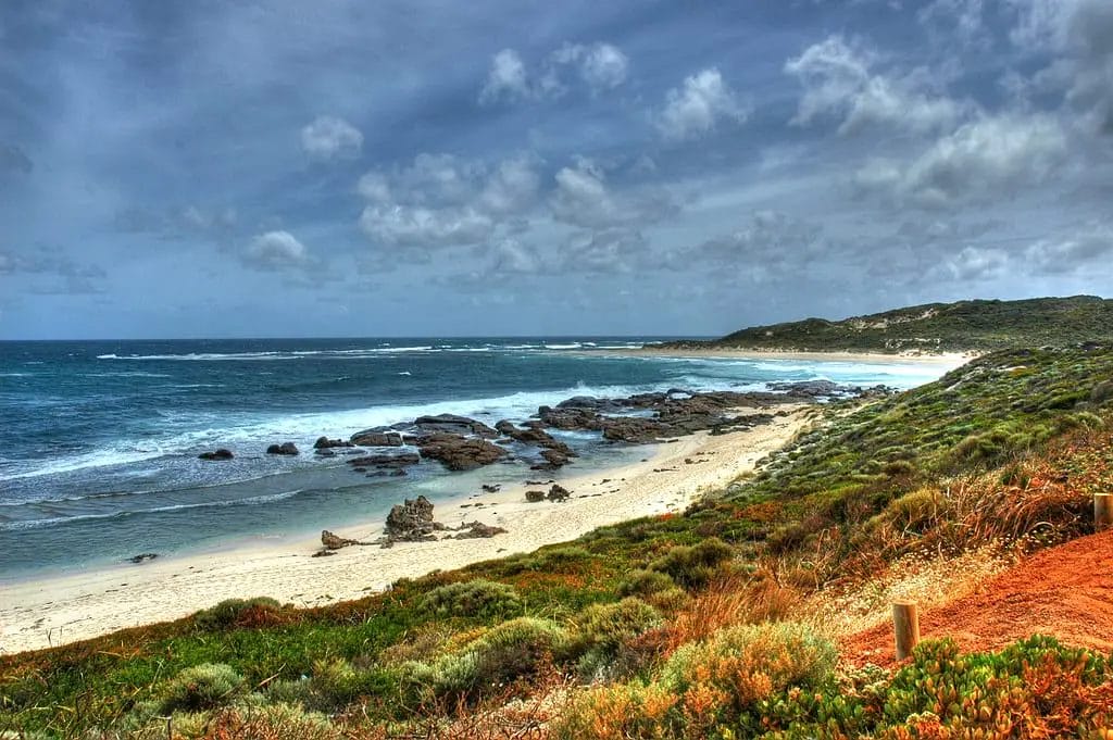 a beach with rocks and water in Margaret River, Western Australia